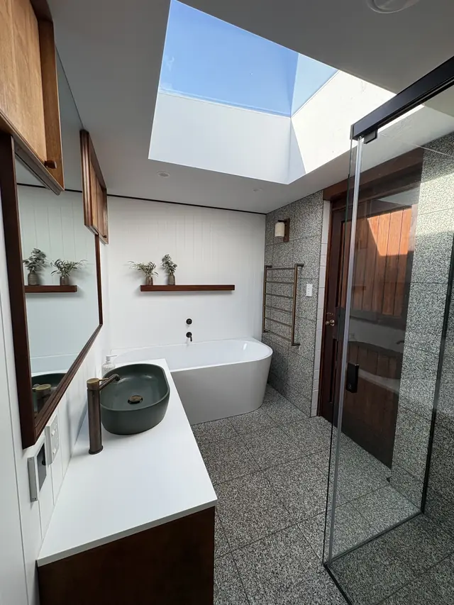 Bathroom with a freestanding bath under a skylight