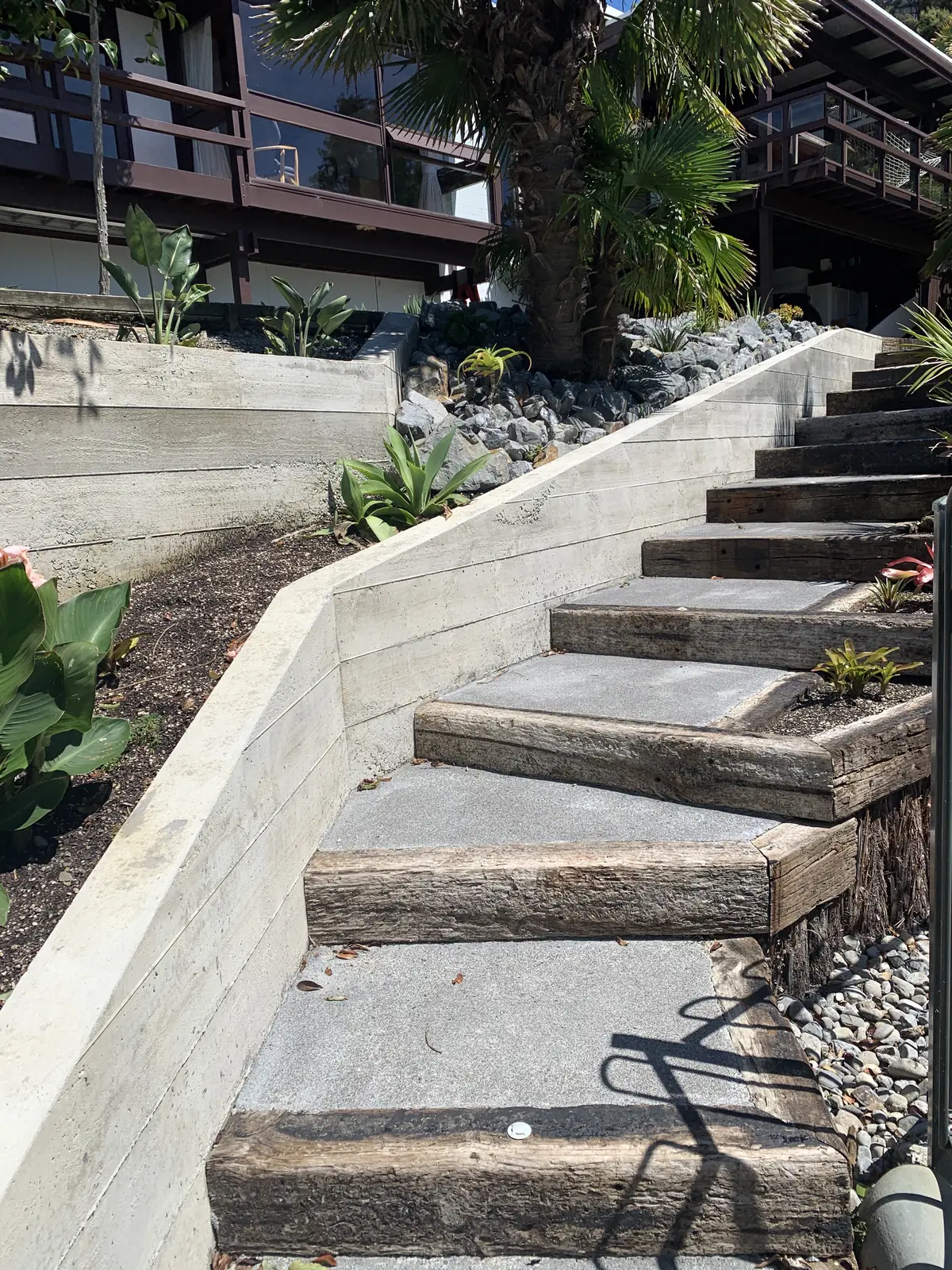 Concrete sleeper steps climbing between retaining walls